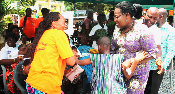 Nana Oye Lithur (right), Minister of Gender, Children and Social Protection (MoGCSP), interacting with a parent and a child with cerebral palsy. PICTURES: MAXWELL OCLOO